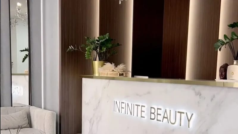 Recepce s podsvíceným nápisem Infinite Beauty